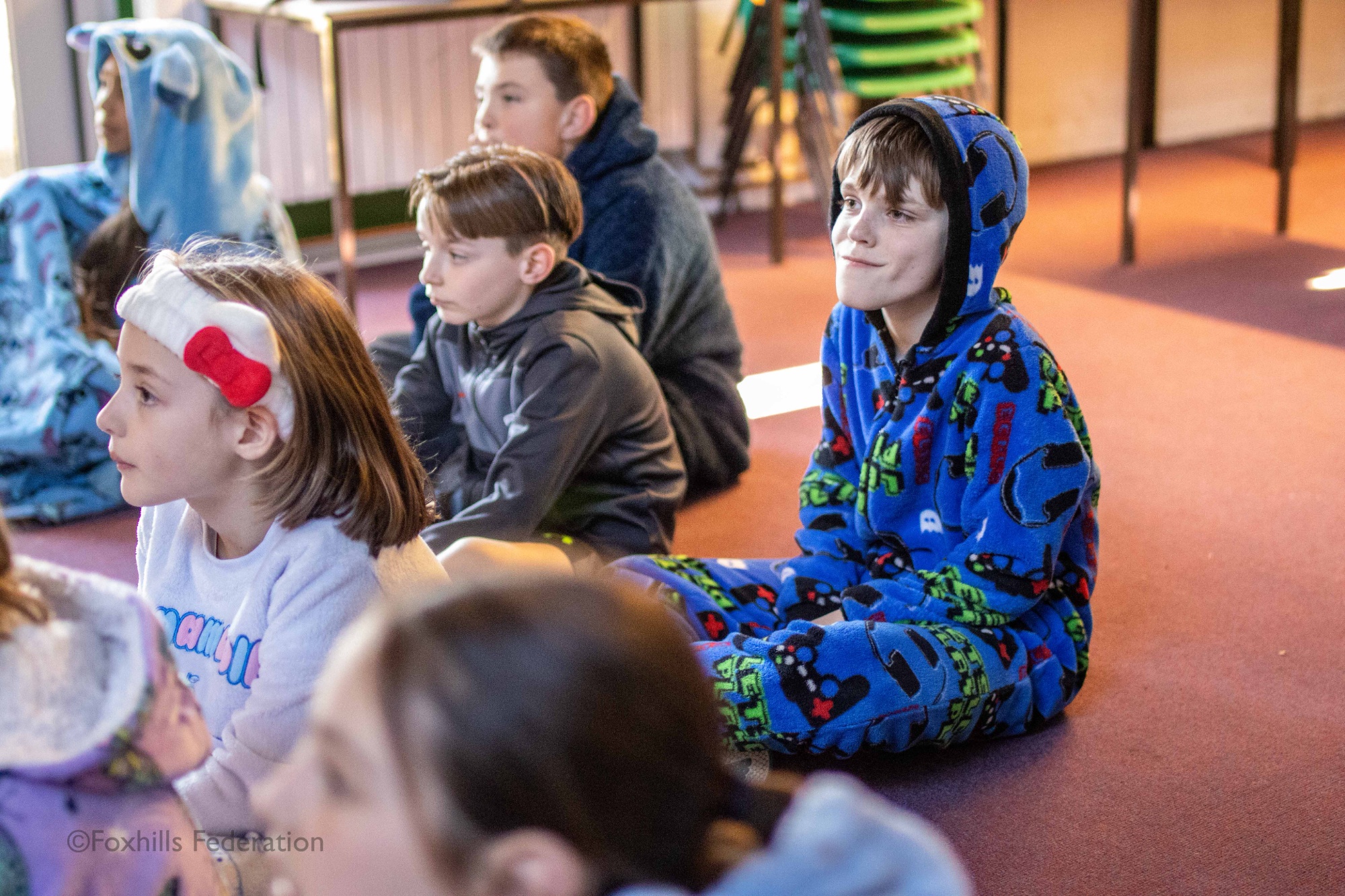 Children listen to a story being read to them