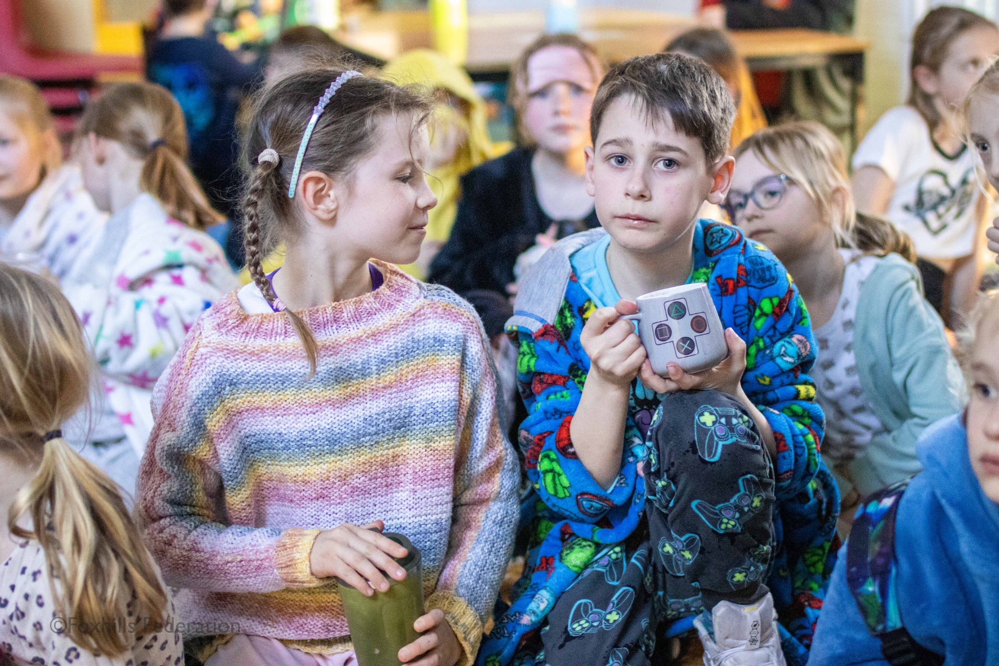 Children eat biscuits while a story is being read to them