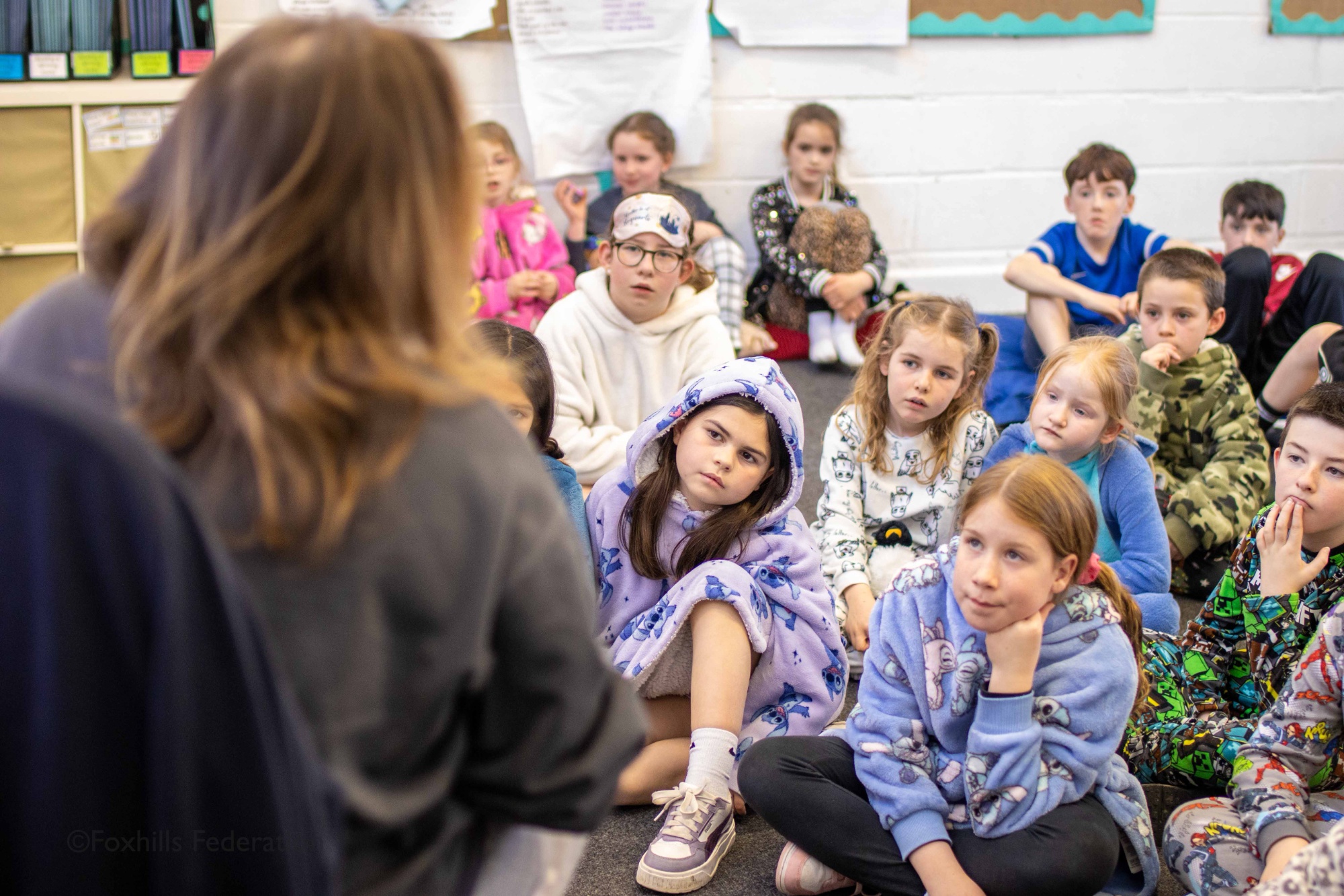 Children listen to a story being read to them