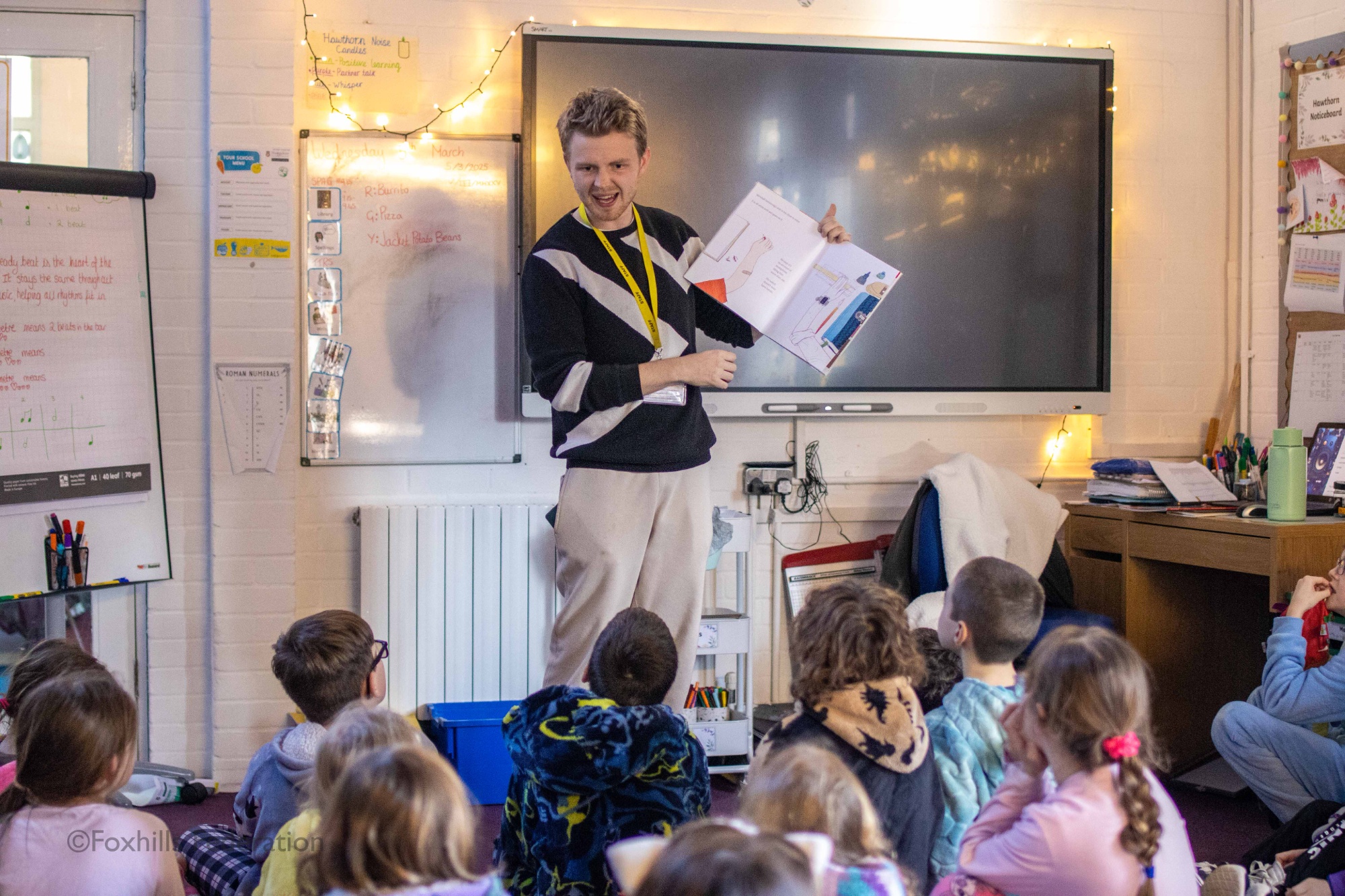 Mr Tustin reads a story to children