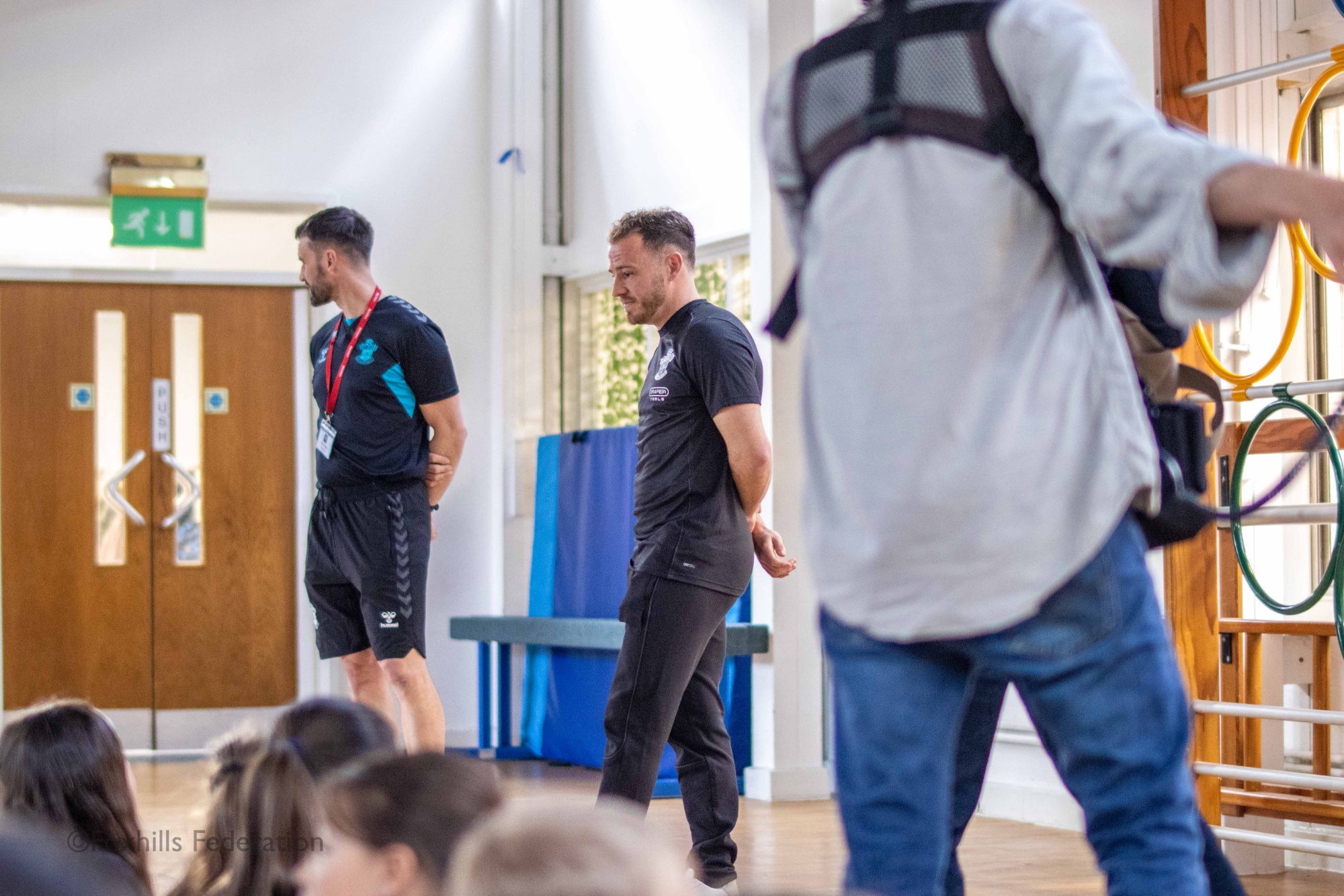 Premier League footballer, Ryan Fraser answers the children’s questions on his career while being filmed by a documentary crew.