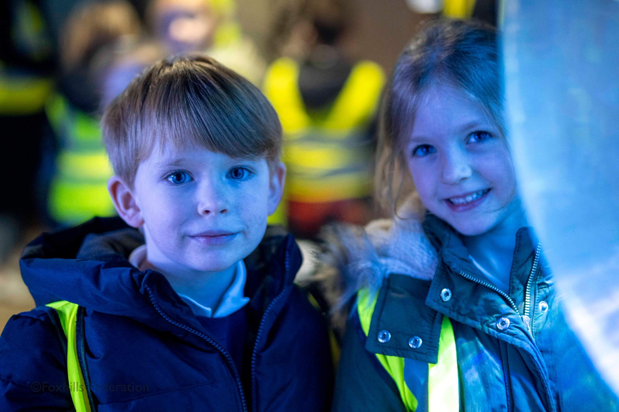 Two children smile at the camera